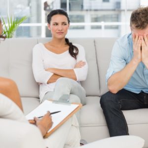 Counseling - Photo club Unhappy couple sitting on sofa at therapy session - 62560358