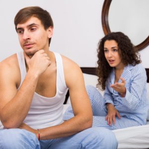 Upset husband and angry wife in bed - Adobe Stock