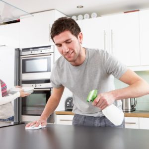 Young Couple Cleaning Cleaning Kitchen -Dollarphotoclub_23438396.jpg