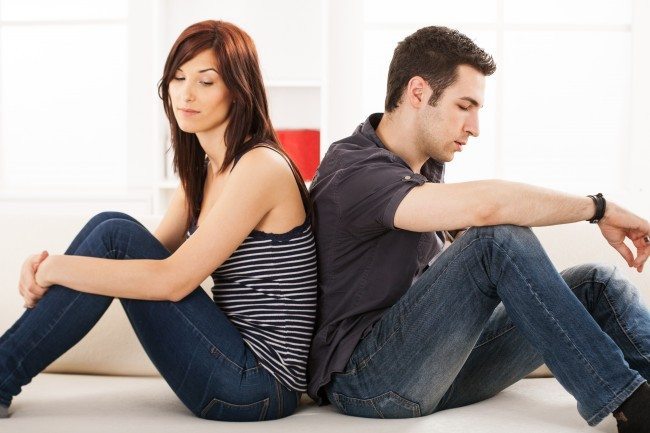 Dollar Photo Young couple sittin back to back on the sofa,having relationship