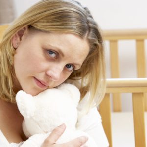 Miscarriage - Sad Mother Sitting In Empty Nursery Photoclub_15935926